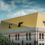 Aufstockung mit goldfarbener Aluminiumfassade auf einem denkmalgeschützten Speichergebäude in Kiel