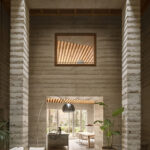 Atrium-Wohnzimmer in Leichtbeton-Bauweise mit Blick in Wohnküche
