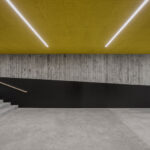 Sichtbetonwände mit Brettschalung und gelbe Decke in einer Turnhalle in Stuttgart