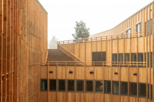 Innenhof mit Holzfassade am Wohngebäude Jonas' von Orange Architects