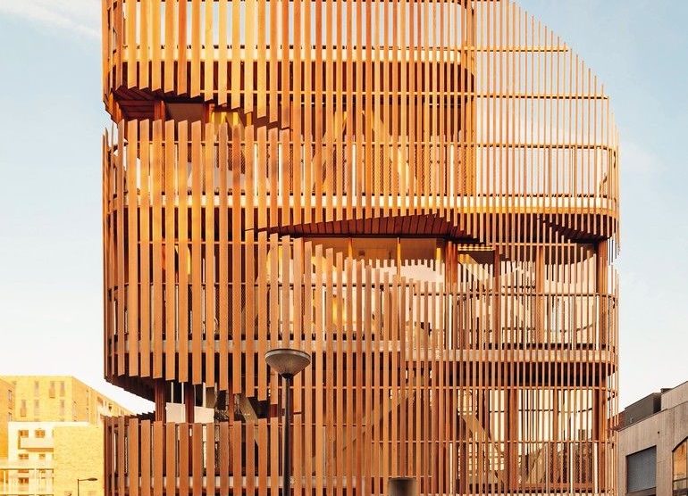 Zedernholz als Lamellenfassade vor geschosshoher Verglasung ermöglicht Tageslichteinfall im Doppelwohnhaus