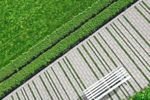 Geometric_background_with_a_white_bench_in_a_green_park._Top_view