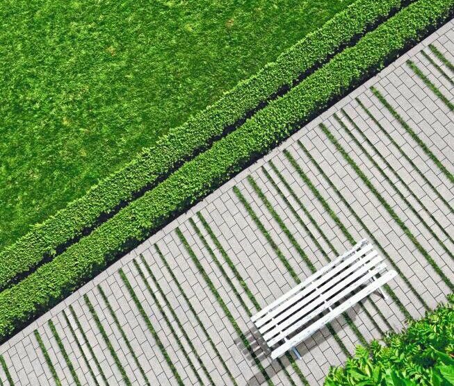 Geometric_background_with_a_white_bench_in_a_green_park._Top_view